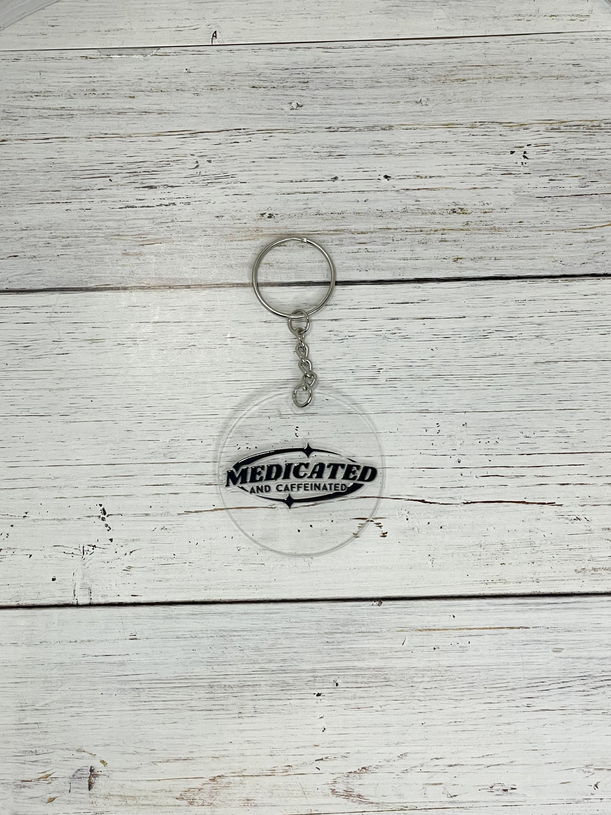 medicated and caffeinated black clear acrylic keychain