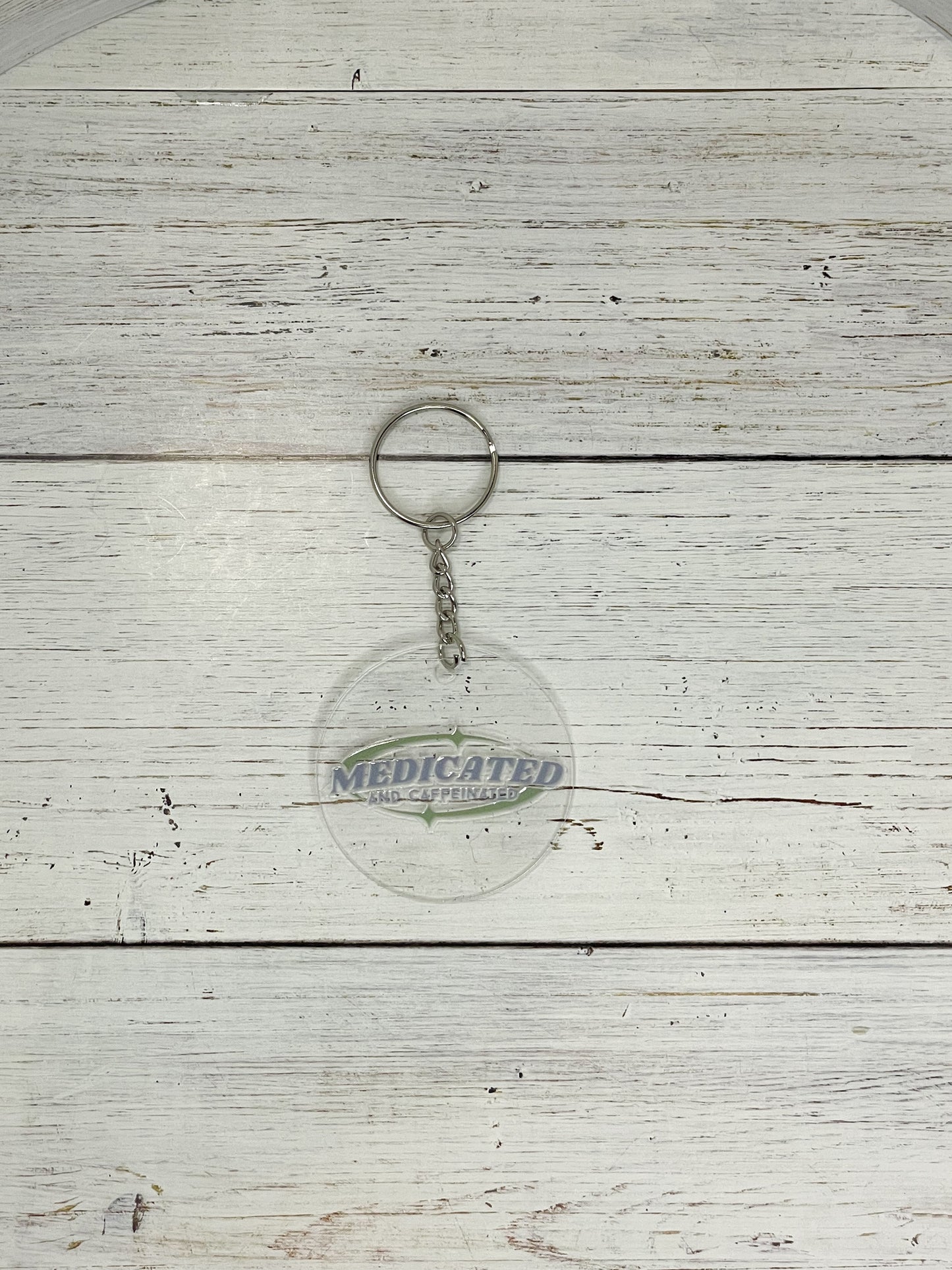 medicated and caffeinated green and blue clear acrylic keychain