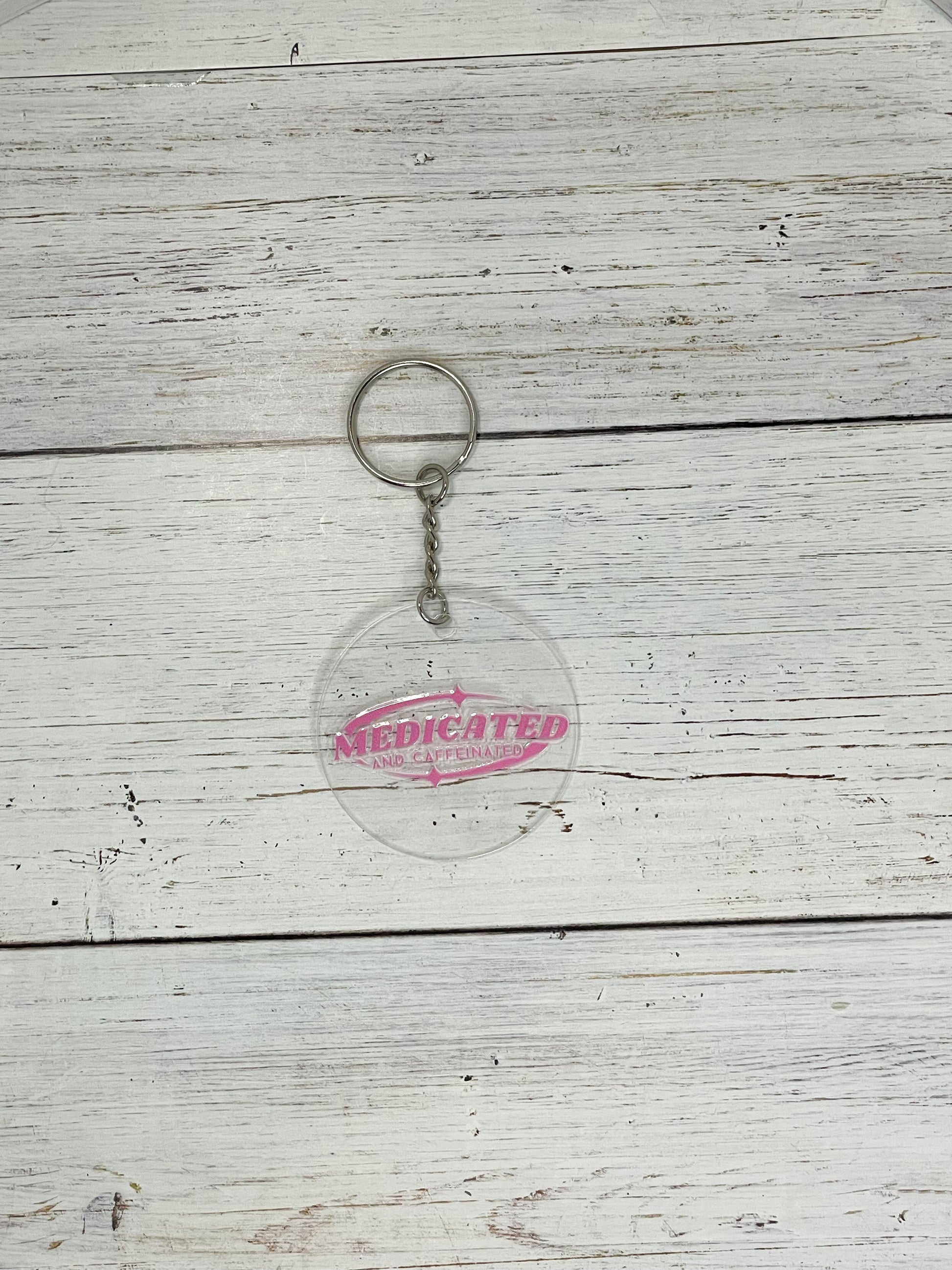 medicated and caffeinated pink clear acrylic keychain