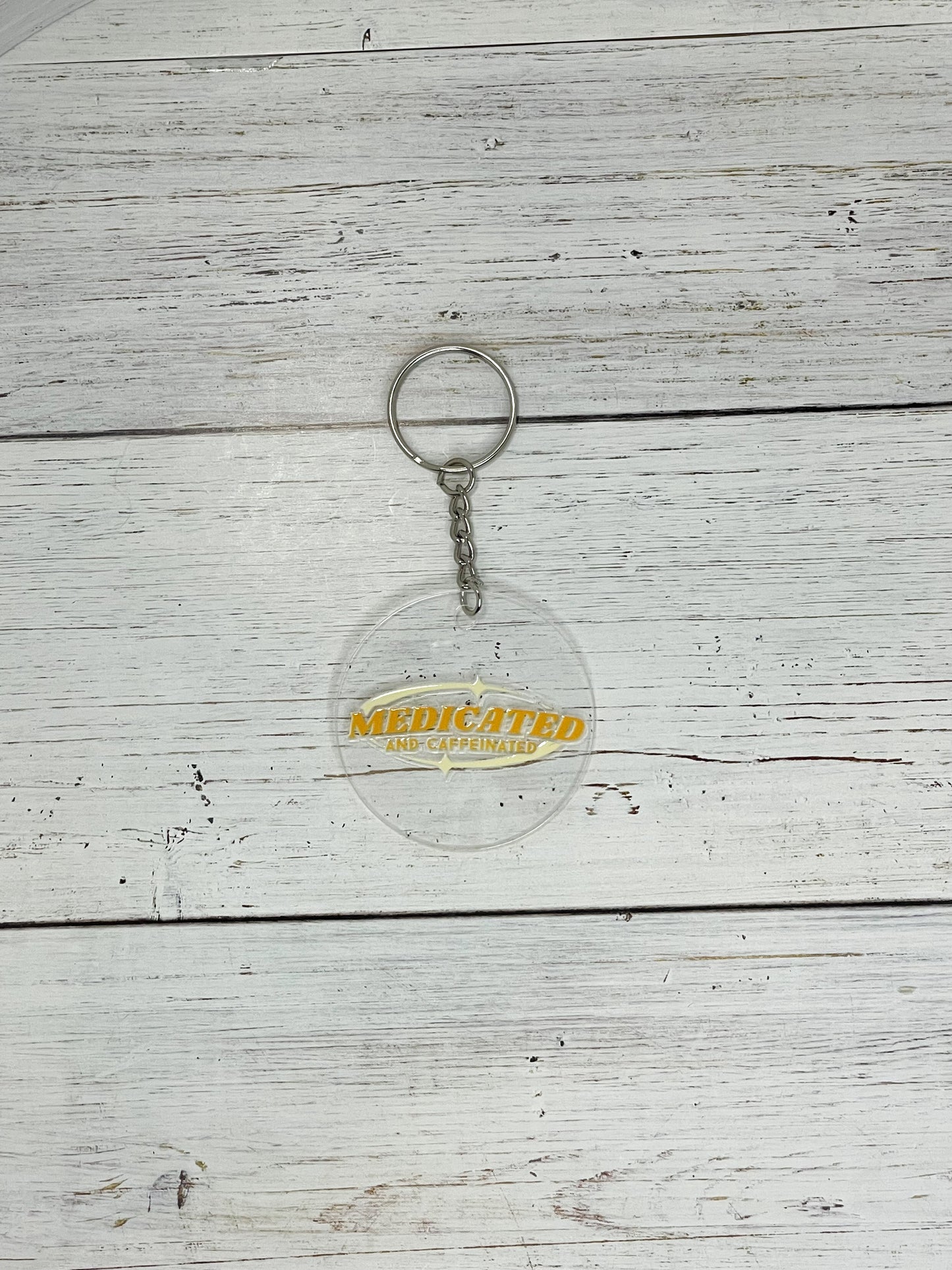 medicated and caffeinated yellow clear acrylic keychain